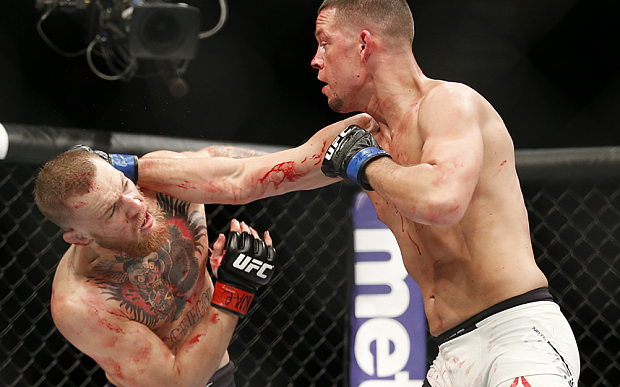 Conor McGregor, left, trades punches with Nate Diaz during their UFC 196 welterweight mixed martial arts match, Saturday, March 5, 2016, in Las Vegas. (AP Photo/Eric Jamison)