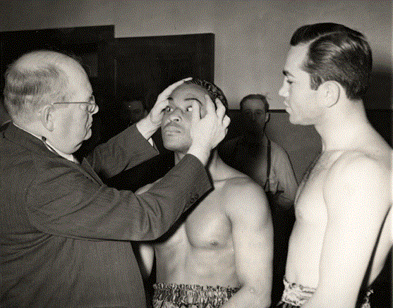Ross looks on as Armstrong is examined by the commission doctor.