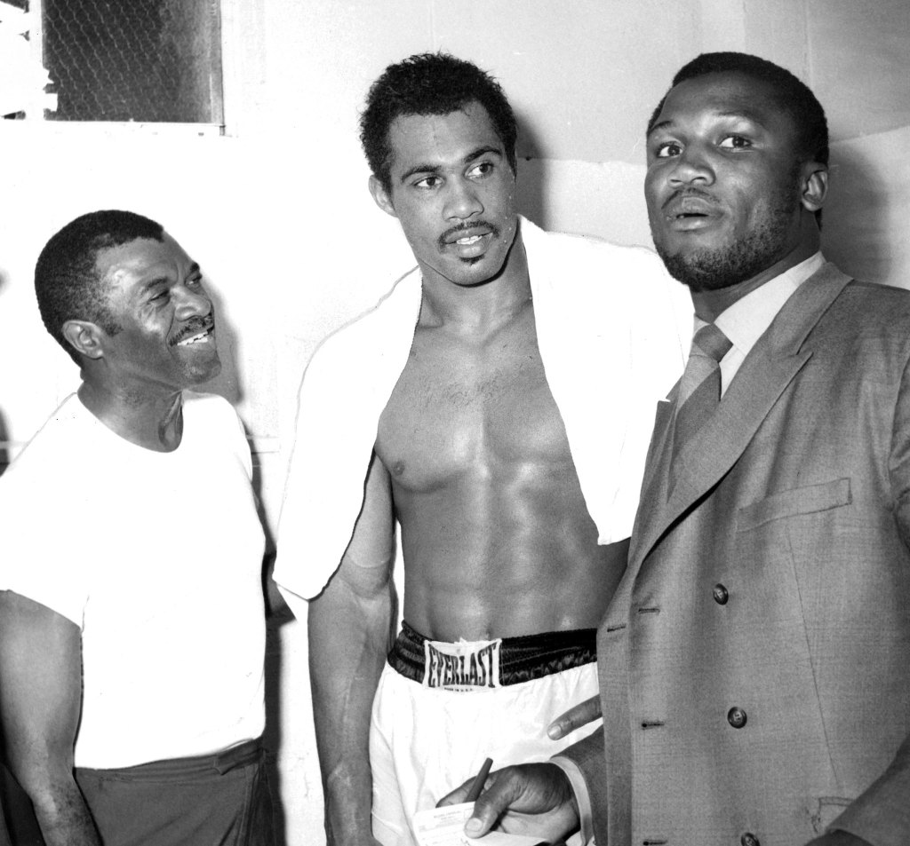 A young Norton (center) with his trainer Eddie Futch (left) and Joe Frazier.