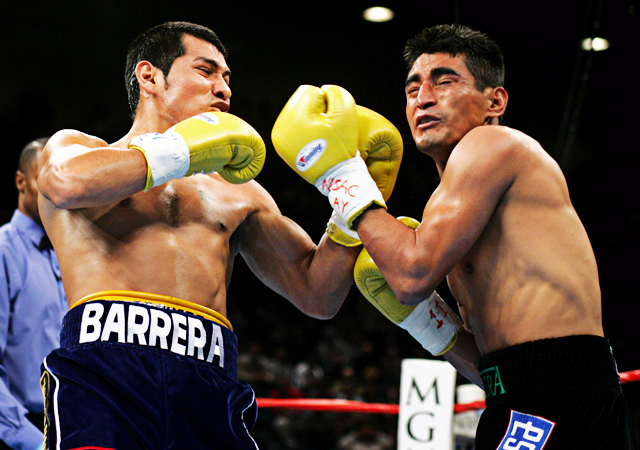 Erik Morales of Tijuana, Mexico (R) exchanges blows with Marco Antonio Barrera of Mexico City, Mexico in the first round of their WBC super featherweight championship fight at the MGM Grand Garden Arena in Las Vegas, Nevada November 27, 2004. REUTERS/Steve Marcus JSH/SH Reuters / Picture supplied by Action Images *** Local Caption *** RBBORH2004112800074.jpg
