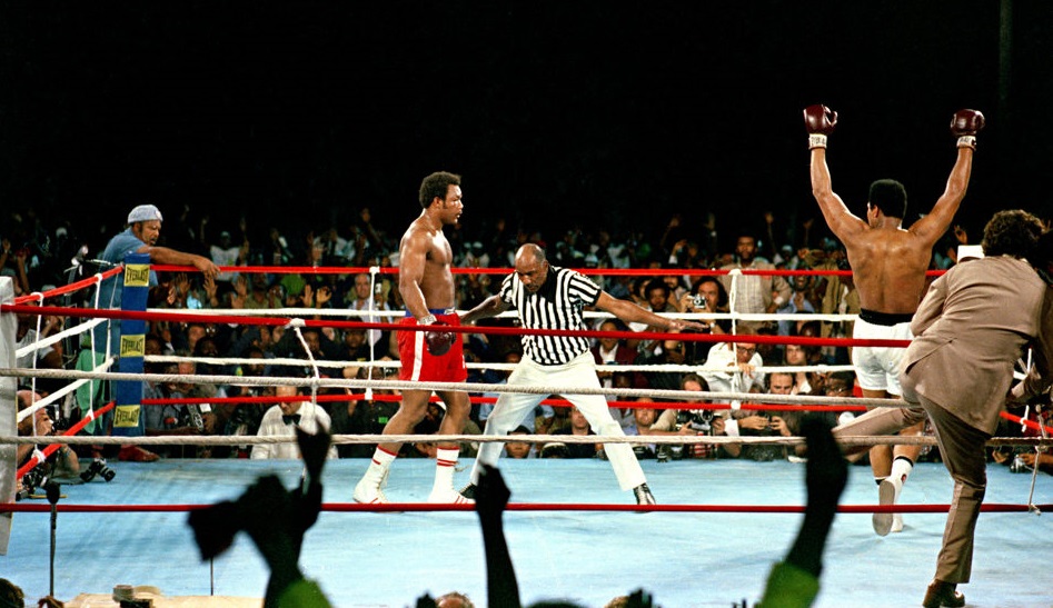 Challenger Muhammad Ali raises his arms in victory after defending champion George Foreman is counted out by referee Zack Clayton, ending the WBA/WBC championship bout in Kinshasa, Zaire, on October 30, 1974. Ali regains the crown as the undisputed heavyweight world champion by KO in the eighth round of their fight dubbed 'Rumble in the Jungle.' (AP Photo)